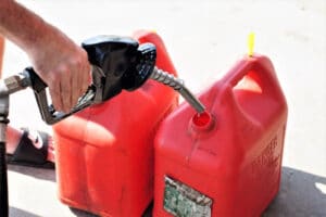 Man filling gas can for lawn mower