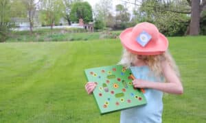 Baby showing seeding square in a green field