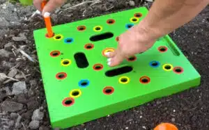 Gardener seeding with a seeding square